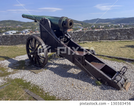 Trencin, Slovakia - August 28, 2025: Medieval cannon under walls of the ancient castle Trencin in Slovakia from the 11th century. 130383456