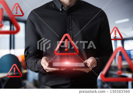 Warning symbols hover around a person using a tablet. Warning symbols hover around a person using a tablet. 130383560