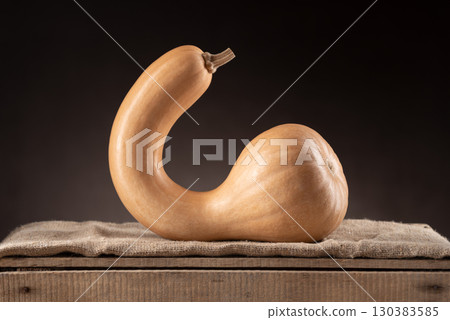 Crookneck Butternut Squash On Wooden Crate With Dark Background Crookneck Butternut Squash On Wooden Crate With Dark Background 130383585