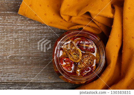Dried cherry tomatoes in oil with herbs, flat lay. 130383831