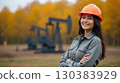 Asian female oilfield technician is at work in autumn. 130383929