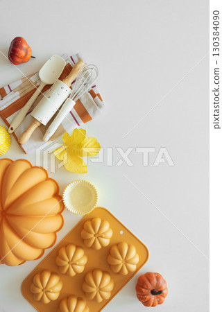 Autumn Baking Setup with Pumpkin Mold, Frosting and Seasonal Decorations 130384090
