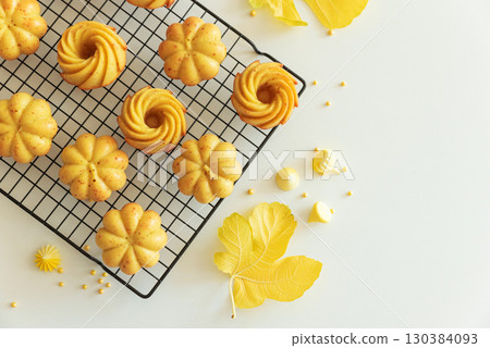Autumn-Themed Mini pumpkin Cakes with Seasonal Decorations on White Background Autumn-Themed Mini pumpkin Cakes with Seasonal Decorations on White Background 130384093