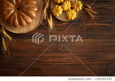 Autumn Harvest Table with Bundt Cake, Pumpkin Cookies and Seasonal Decor 130384107