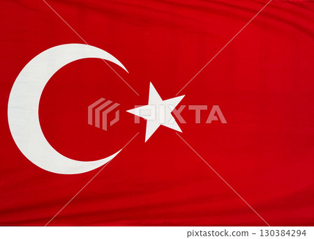 Turkish national flag with white crescent and star on a red background. Identity, patriotism and cultural pride in national symbols. Turkish national flag with white crescent and star on a red background. Identity, patriotism and cultural pride in national symbols. 130384294