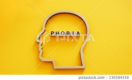 Head outline with the word phobia. Mental health and psychological fear. Head outline with the word phobia. Mental health and psychological fear. 130384338