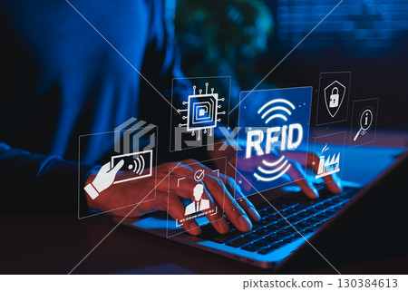RFID Technology Concept. Radio Frequency Identification. Person using laptop with digital icons illustrating RFID tech, data chips, access control, security systems for smart industrial applications, 130384613