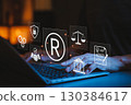 Registered Trademark and Intellectual Property Protection Concept. Typing on laptop with trademark symbol and legal icons, intellectual property, legal rights, brand protection, and business security. 130384617