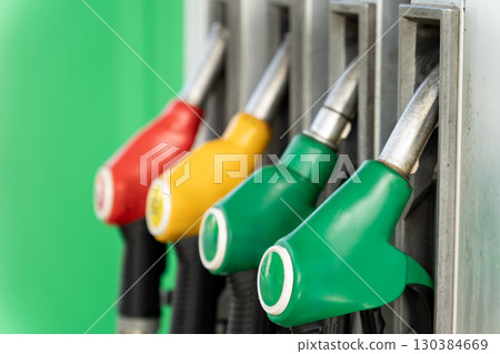 Close-up of four fuel dispensing nozzles on a gas pump Close-up of four fuel dispensing nozzles on a gas pump 130384669