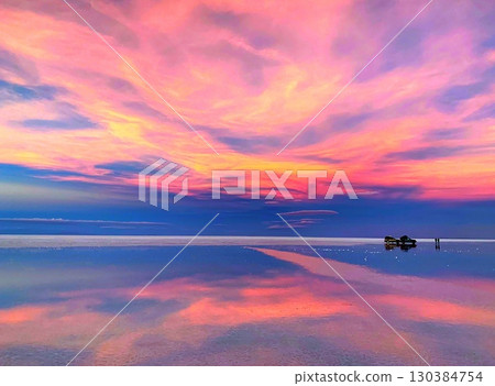 Vibrant sunset sky over lake in Salar de Uyuni Bolivia Vibrant sunset sky over lake in Salar de Uyuni Bolivia 130384754