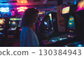 Young woman concentrating while playing pinball in a vintage arcade full of colorful neon lights, creating a nostalgic and entertaining atmosphere 130384943