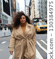 Confident plus size model is strolling through the bustling streets of new york city. Showcasing her impeccable style in a trendy trench coat and turtleneck. Embodying urban chic and body positivity 130384975