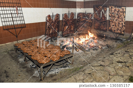 Barbecue, sausage and cow ribs, traditional argentine cuisine, Patagonia, Argentina. 130385157