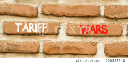 Trade tariff wars symbol. Concept word Tariff wars on beautiful old brown brick wall. Beautiful old brown brick wall background. Old brick wall. Business trade tariff wars concept. Copy space. 130385348