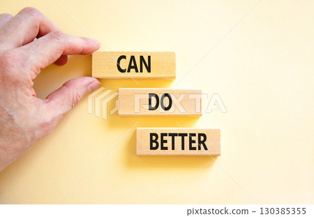 Can do better symbol. Concept words Can do better on beautiful wooden block. Businessman's hand. Beautiful white background. Business and can do better concept. Copy space. 130385355