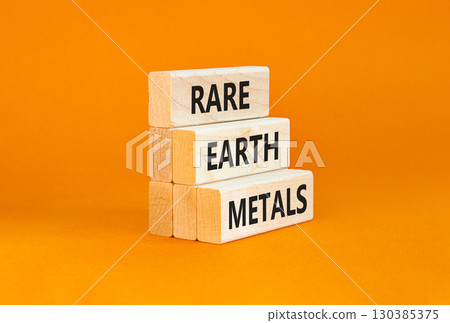 Rare earth metals symbol. Concept words Rare earth metals on beautiful wooden block. Beautiful orange table orange background. Business and rare earth metals concept. Copy space. 130385375