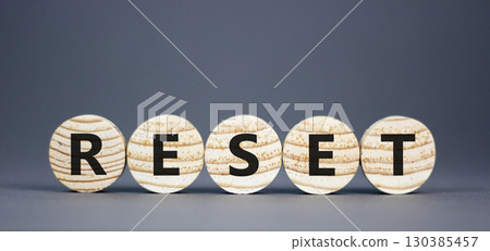 Reset symbol. Concept word Reset on beautiful wooden circles. Beautiful grey table grey background. Business lifestyle reset concept. Copy space. 130385457