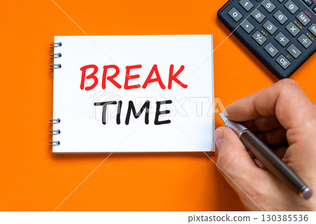 Break time symbol. Concept word Break time on beautiful white note. Businessman's hand. Black calculator. Beautiful orange paper background. Business break time concept. Copy space. 130385536