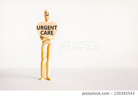 Urgent care symbol. Concept words Urgent care on beautiful wooden heart. Doctor's model. Beautiful white background. Copy space. Medical healthy lifestyle urgent care concept. 130385543