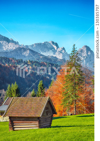 Fabulous view of alpine meadow with wooden huts  near Wagenbruchsee (Geroldsee) lake 130385707