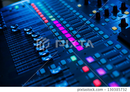 Concert sound mixer panel with volume regulators. Professional audio and light equipment for sound recording studio, live music broadcasting, television, party. mixing console. audio signals Concert sound mixer panel with volume regulators. Professional audio and light equipment for sound recording studio, live music broadcasting, television, party. mixing console. audio signals 130385732