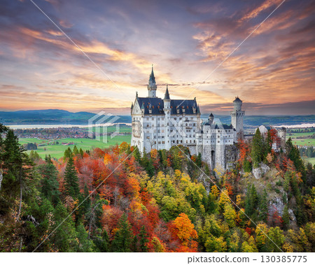 Amazing autumn view of famous Neuschwanstein Castle at sunset. Amazing autumn view of famous Neuschwanstein Castle at sunset. 130385775