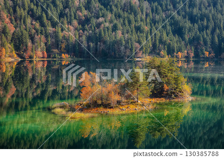 Fabulous autumn landscape of islands with pine-trees in the middle of Eibsee lake. Fabulous autumn landscape of islands with pine-trees in the middle of Eibsee lake. 130385788