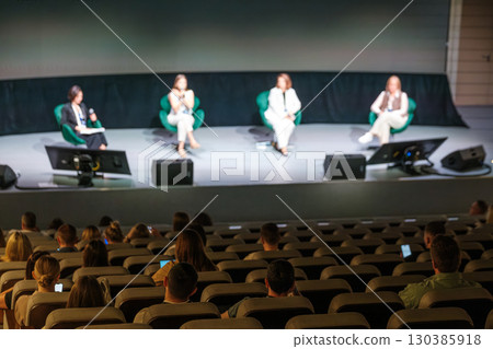 Panel discussion with audience in modern conference room setting Panel discussion with audience in modern conference room setting 130385918