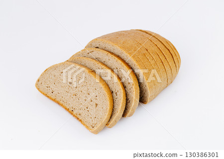 Sliced rye bread loaf isolated on white background, healthy whole grain bakery product 130386301