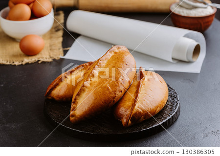 Freshly baked Ukrainian pies on rustic background, homemade traditional pastries, heritage food Freshly baked Ukrainian pies on rustic background, homemade traditional pastries, heritage food 130386305