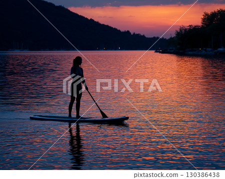Illustration of a woman doing SUP on a lake 130386438