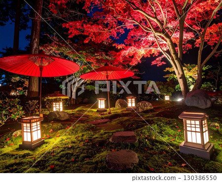 A fantastic garden illumination featuring red umbrellas and lanterns A fantastic garden illumination featuring red umbrellas and lanterns 130386550