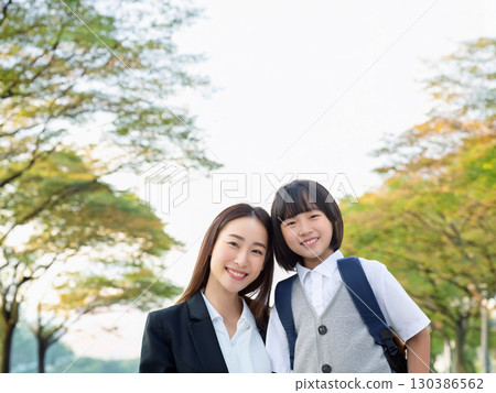 Smiling mother and daughter playing in the park Smiling mother and daughter playing in the park 130386562