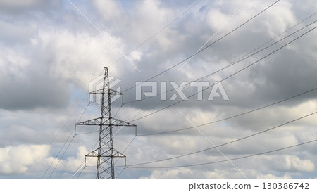 Dynamic Power Lines Set Against a Dramatic Cloudy Sky Filled with Various Textures and Colors Dynamic Power Lines Set Against a Dramatic Cloudy Sky Filled with Various Textures and Colors 130386742