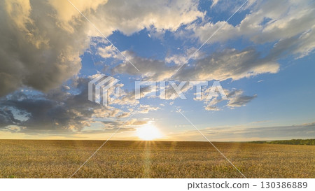 A Breathtaking Sunset Over a Beautiful wheat Field, Capturing a Moment of Tranquility and Calmness 130386889