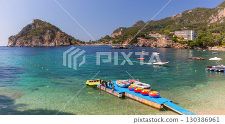 Beach and pier in Paleokastritsa Corfu Greece Beach and pier in Paleokastritsa Corfu Greece 130386961