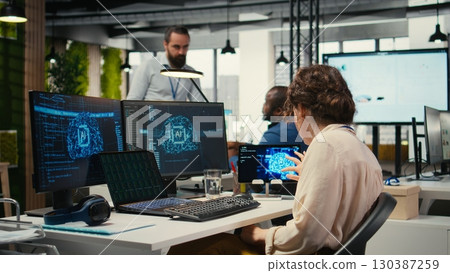 Office administrator checking monthly reports with AI analytics platform, employing neural networks algorithms and automation for business productivity. IT company representative at work. Office administrator checking monthly reports with AI analytics platform, employing neural networks algorithms and automation for business productivity. IT company representative at work. 130387259