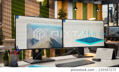 Wind turbine simulation on PC screens in research and development office. CAD software on computer monitors supporting renewable energy engineering and sustainable technology innovation 130387275