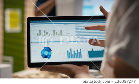 Woman property engineer searching layout details on laptop in the office, working on urban development for a residential construction project in innovation hub. Construction site. 130387277