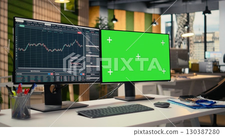 Trading software in proprietary firm office with graphs on green screen PC monitors. Chroma key computers on desk used by financial experts tracking stock market activity using analytical tools 130387280
