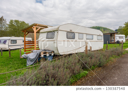Vintage travel trailer in green campsite near Slapy lake in Czech Republic in spring Vintage travel trailer in green campsite near Slapy lake in Czech Republic in spring 130387548