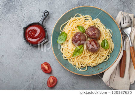 Delicious spaghetti with meatballs on plate, tomato sauce and basil on gray background top view 130387620