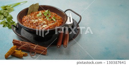 Dal makhani with cream and coriander in bowl is served with spices, traditional dish of India, space for text 130387641
