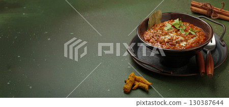 Dal makhani with cream and coriander in bowl is served with spices, traditional dish of India, space for text 130387644