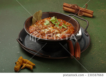 Dal makhani with cream and coriander in bowl is served with spices, traditional dish of India 130387668