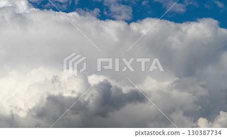 A Dramatic Cloudscape Overhead Accompanied by a Beautiful and Vivid Blue Sky Above 130387734