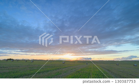 A Serene Sunrise Unfolds Over Endless Fields, Showcasing the Beauty of Natures Splendor 130387753