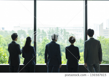 Businessman and business woman talking in the lounge Businessman and business woman talking in the lounge 130387815