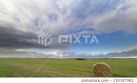 A vast, open field sprawls beneath stunning skies that evoke deep wonder and awe 130387962