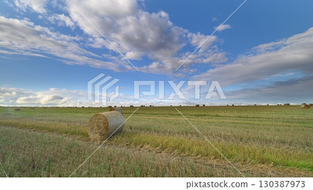 Explore the Scenic and Picturesque Rural Landscape Featuring Hay Bales Beneath a Beautiful Sky Explore the Scenic and Picturesque Rural Landscape Featuring Hay Bales Beneath a Beautiful Sky 130387973